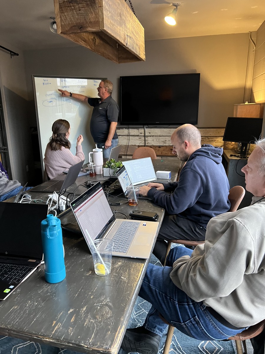 Michael at whiteboard with team
